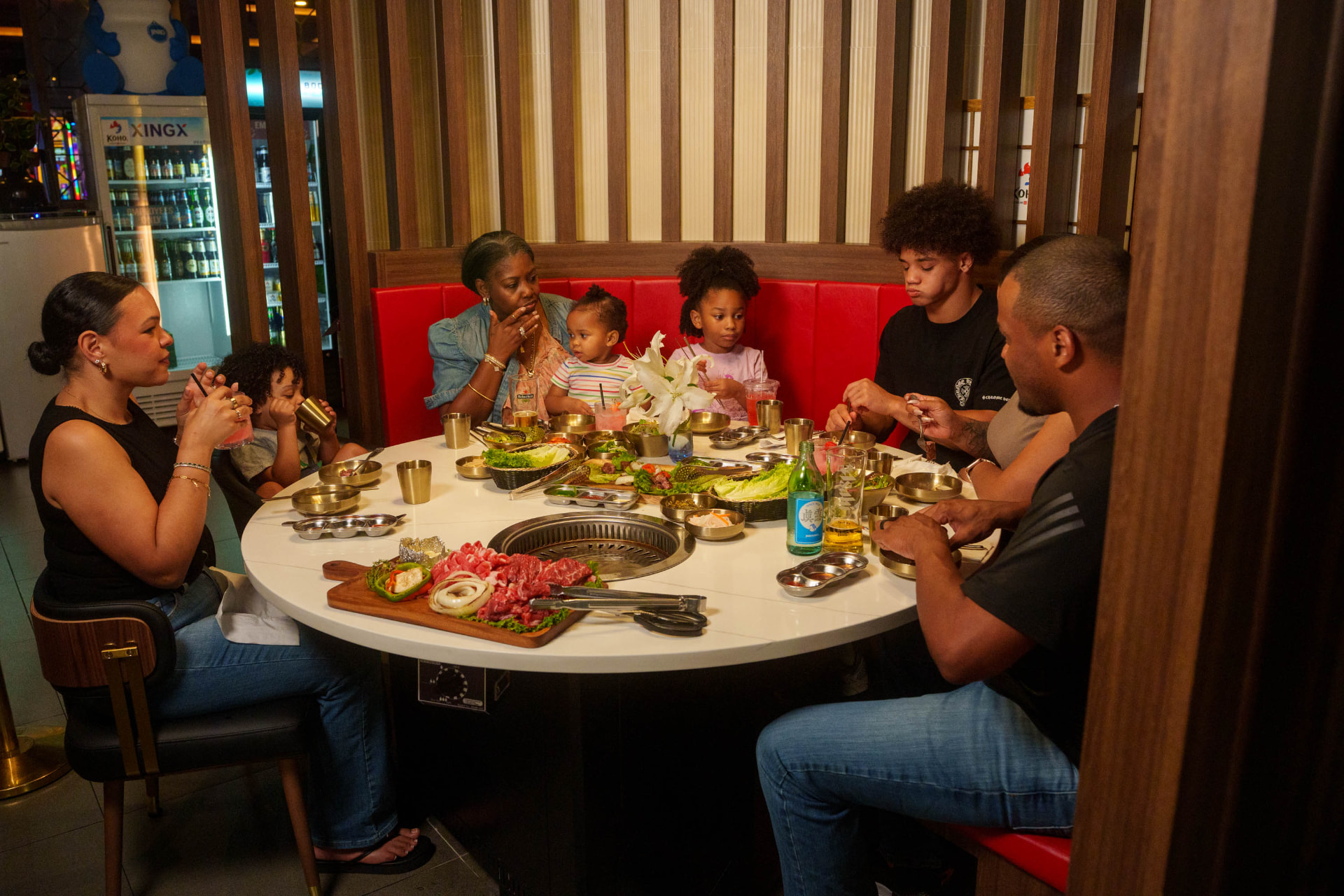 Family sharing a Korean BBQ meal together at Koho